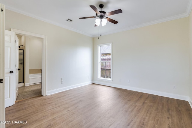 spare room with baseboards, ceiling fan, ornamental molding, and wood finished floors