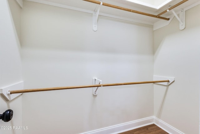 spacious closet with dark wood-style flooring