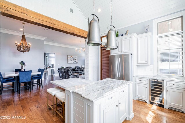 104 Peaceful Hollow Ln, Lafayette, LA 70508 - kitchen with wine cooler, white cabinets, freestanding refrigerator, and a chandelier