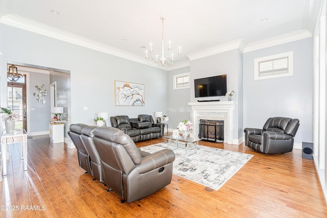 104 Peaceful Hollow Ln, Lafayette, LA 70508 - living room with crown molding, wood finished floors, a chandelier, and a tile fireplace