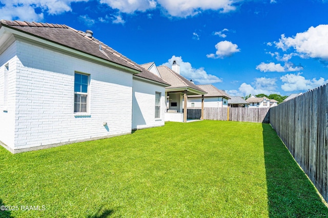 104 Peaceful Hollow Ln, Lafayette, LA 70508 - rear view of house featuring a fenced backyard, a yard, and brick siding