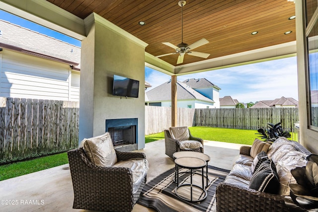 104 Peaceful Hollow Ln, Lafayette, LA 70508 - view of patio with a fenced backyard, a ceiling fan, and a large fireplace