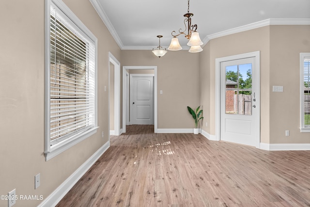 1115 Jules Broussard Rd, Breaux Bridge, LA 70517 - unfurnished dining area with an inviting chandelier, ornamental molding, baseboards, and wood finished floors