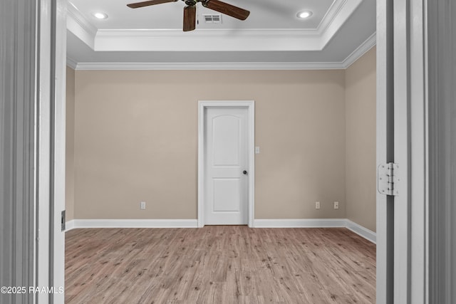 1115 Jules Broussard Rd, Breaux Bridge, LA 70517 - empty room featuring ceiling fan, visible vents, crown molding, wood finished floors, and a tray ceiling