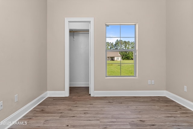1115 Jules Broussard Rd, Breaux Bridge, LA 70517 - unfurnished bedroom with a closet, baseboards, wood finished floors, and a spacious closet