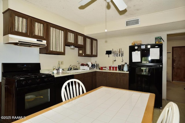 118 Fraternity Dr, Lafayette, LA 70506 - kitchen with a ceiling fan, visible vents, dark brown cabinets, black appliances, and under cabinet range hood