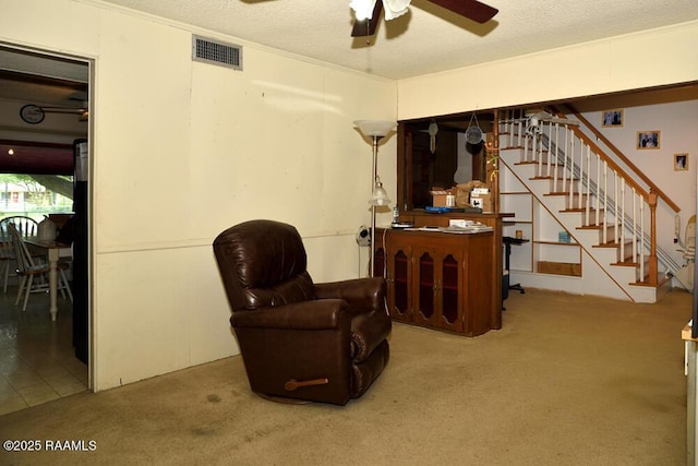118 Fraternity Dr, Lafayette, LA 70506 - living area with visible vents, carpet floors, stairs, a textured ceiling, and a ceiling fan