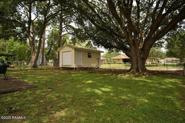 118 Fraternity Dr, Lafayette, LA 70506 - view of yard featuring an outdoor structure, a fenced backyard, and a storage shed