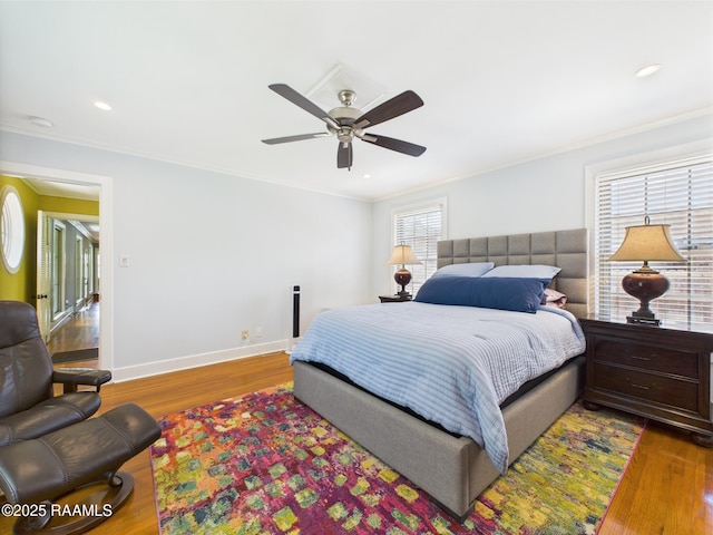 bedroom featuring crown molding, baseboards, ceiling fan, and wood finished floors