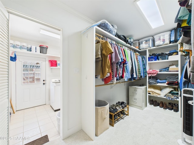 spacious closet featuring washer / dryer and tile patterned flooring