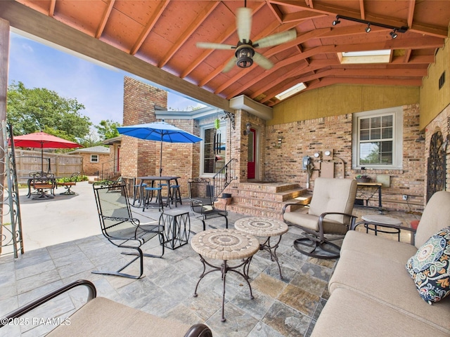 view of patio / terrace featuring fence, outdoor dining space, and ceiling fan