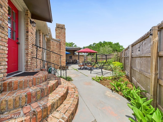 exterior space featuring a fenced backyard and outdoor dining area