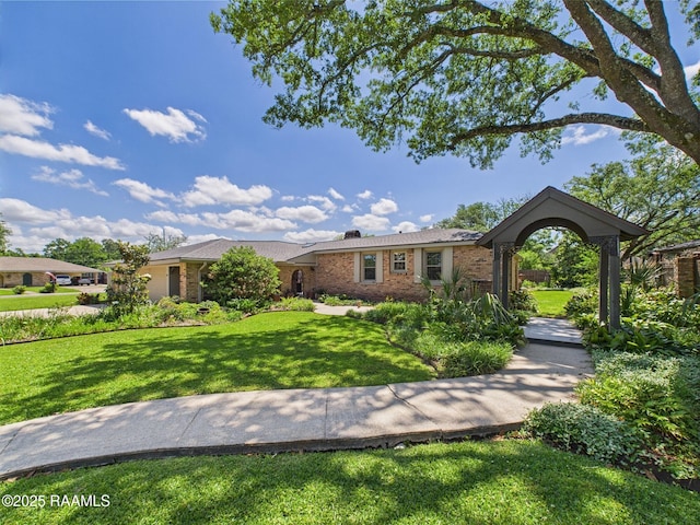 ranch-style house with a chimney, a front lawn, and brick siding