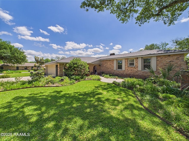 ranch-style home with a garage, driveway, a front lawn, and brick siding