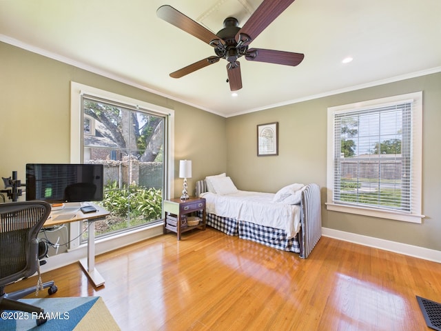 bedroom featuring baseboards, visible vents, ornamental molding, and light wood-type flooring