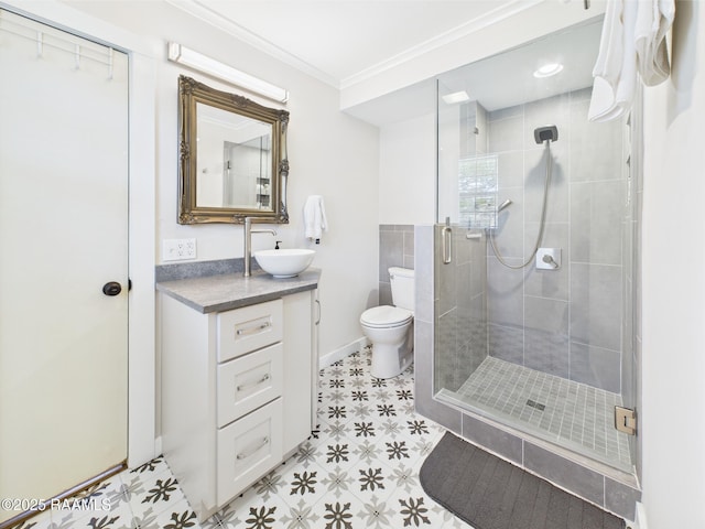 bathroom featuring crown molding, vanity, toilet, baseboards, and a shower stall