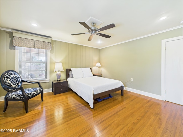 bedroom with crown molding, baseboards, ceiling fan, and light wood-type flooring