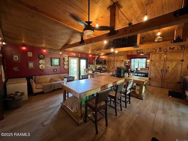 dining area with french doors, light wood-style flooring, a ceiling fan, wooden ceiling, and vaulted ceiling with beams