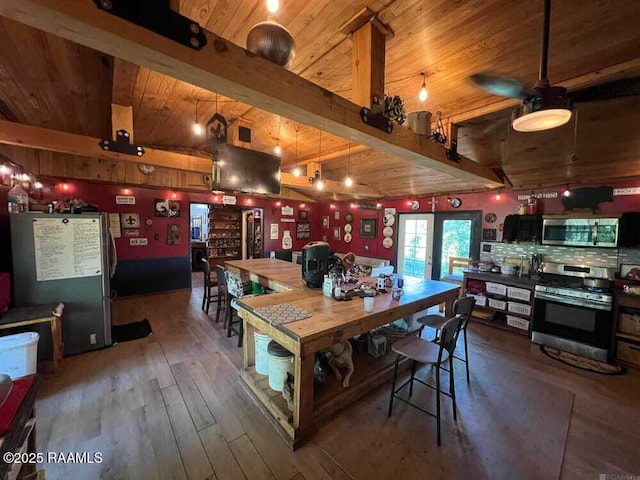 dining space featuring a ceiling fan, beam ceiling, hardwood / wood-style floors, and wooden ceiling