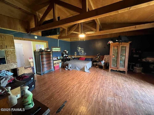 bedroom featuring wood finished floors, high vaulted ceiling, and beamed ceiling