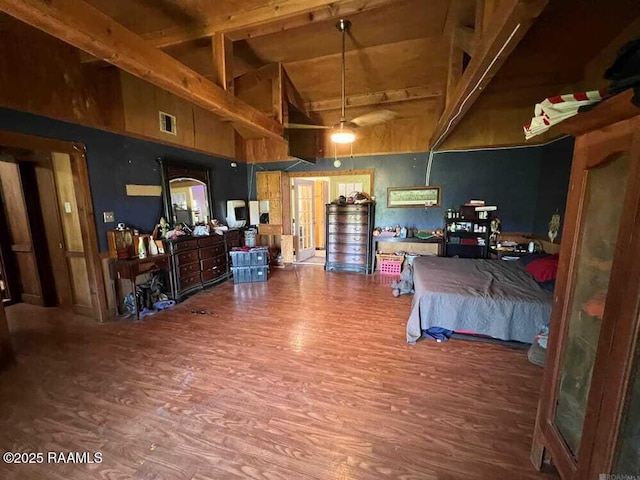 miscellaneous room with high vaulted ceiling, beam ceiling, wood finished floors, and visible vents