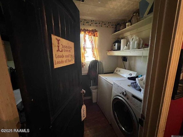 washroom with washing machine and clothes dryer and laundry area