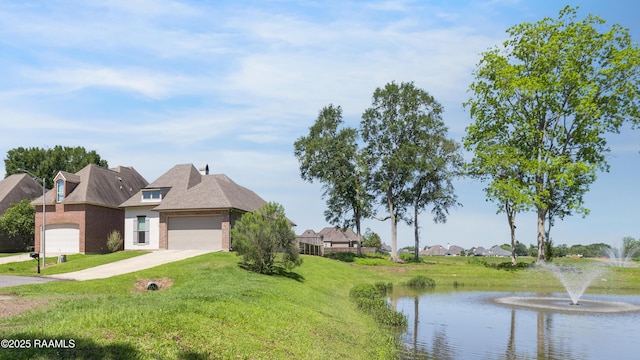 147 Heathwood Dr, Broussard, LA 70518 - view of front of house featuring brick siding, a front lawn, a water view, driveway, and an attached garage