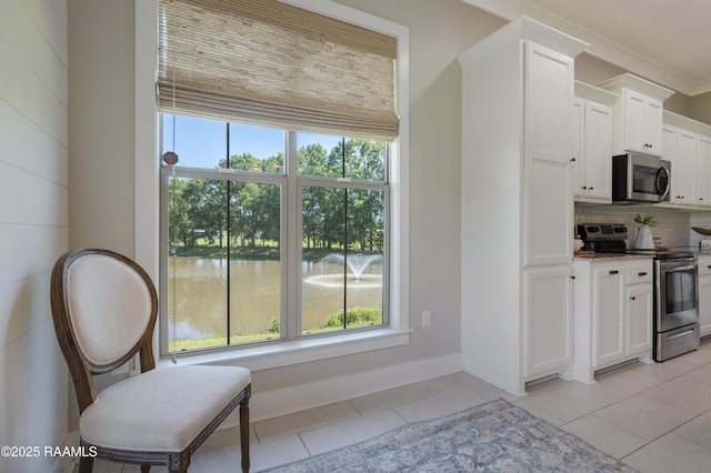 147 Heathwood Dr, Broussard, LA 70518 - kitchen with appliances with stainless steel finishes, plenty of natural light, tasteful backsplash, and light tile patterned flooring