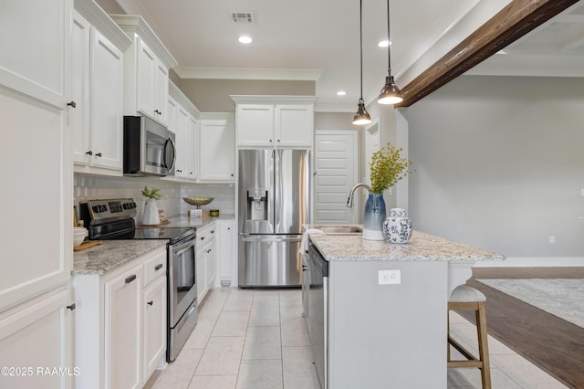 147 Heathwood Dr, Broussard, LA 70518 - kitchen with appliances with stainless steel finishes, a sink, light tile patterned floors, an island with sink, and tasteful backsplash