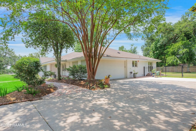 1022 Roselawn Dr, Lafayette, LA 70503 - view of front of house with fence, an attached garage, and driveway