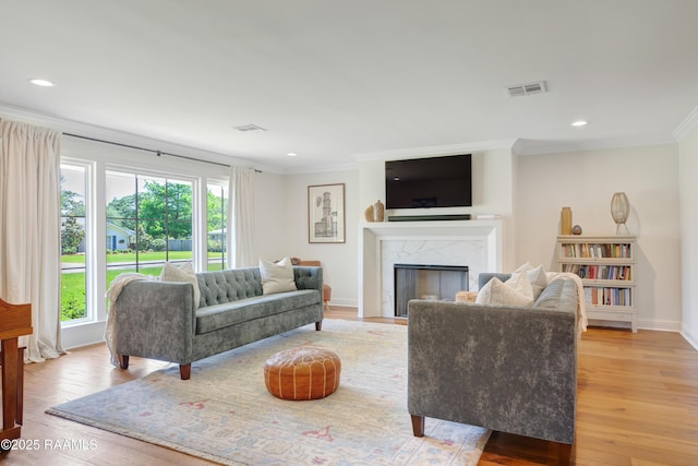 1022 Roselawn Dr, Lafayette, LA 70503 - living room with visible vents, ornamental molding, light wood-style floors, and a fireplace