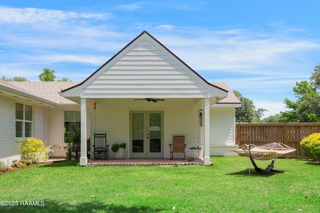 1022 Roselawn Dr, Lafayette, LA 70503 - back of property featuring fence, french doors, a ceiling fan, a shingled roof, and a lawn