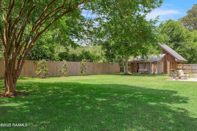 1022 Roselawn Dr, Lafayette, LA 70503 - view of yard featuring an outdoor structure, a fenced backyard, and a shed