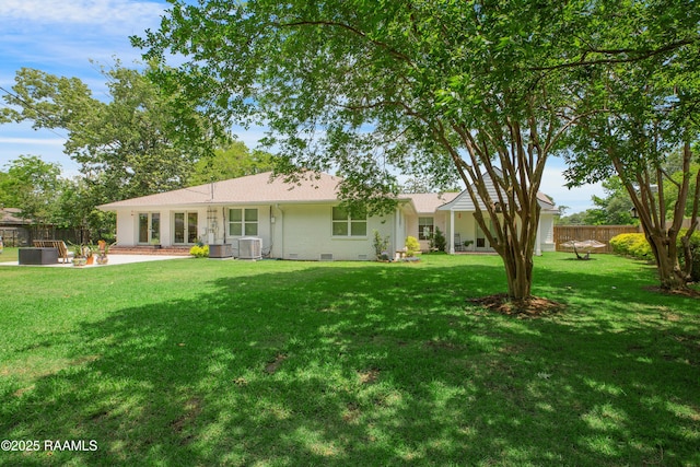 1022 Roselawn Dr, Lafayette, LA 70503 - back of house featuring fence, a patio, brick siding, central AC unit, and a lawn