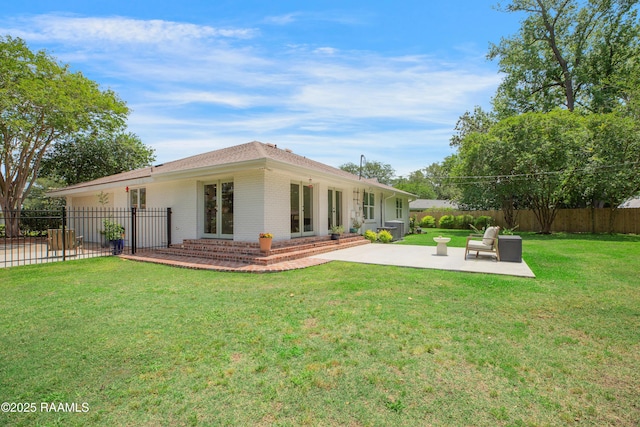 1022 Roselawn Dr, Lafayette, LA 70503 - back of house featuring a lawn, brick siding, a fenced backyard, and a patio area