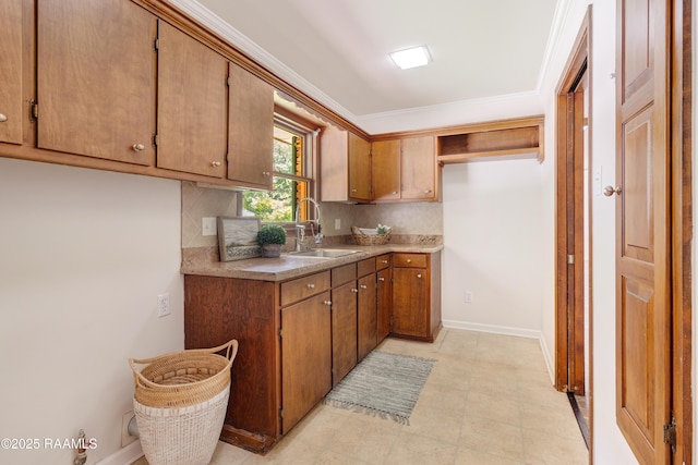 201 W Eleanor St, Opelousas, LA 70570 - kitchen with tasteful backsplash, brown cabinetry, ornamental molding, and light countertops