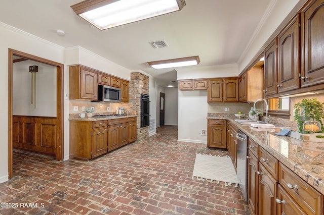 201 W Eleanor St, Opelousas, LA 70570 - kitchen featuring appliances with stainless steel finishes, brick flooring, backsplash, brown cabinets, and ornamental molding