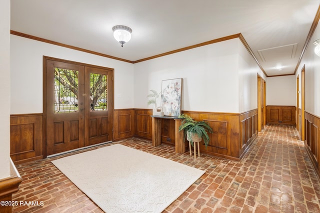 201 W Eleanor St, Opelousas, LA 70570 - foyer entrance with brick floors, a wainscoted wall, wood walls, crown molding, and french doors