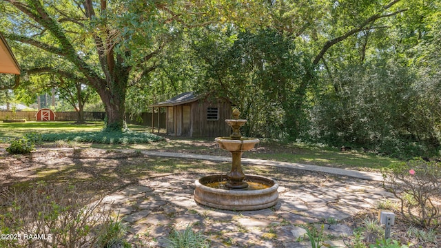 201 W Eleanor St, Opelousas, LA 70570 - fenced backyard featuring a storage unit and a patio