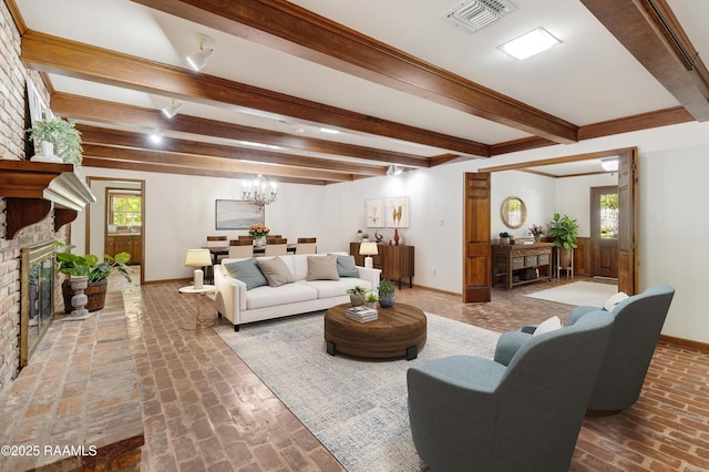 201 W Eleanor St, Opelousas, LA 70570 - living room with beamed ceiling, a fireplace, brick flooring, and a chandelier