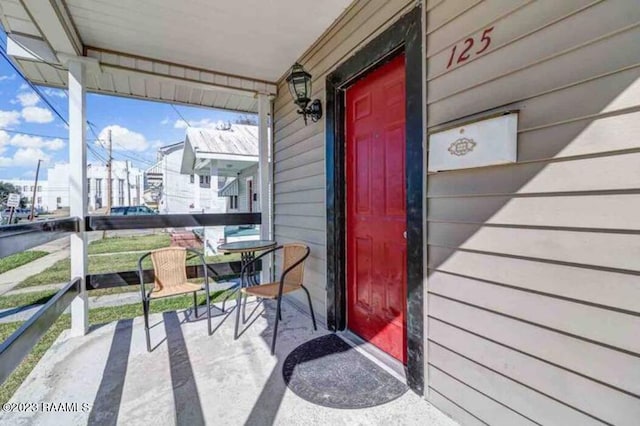 view of exterior entry featuring a porch
