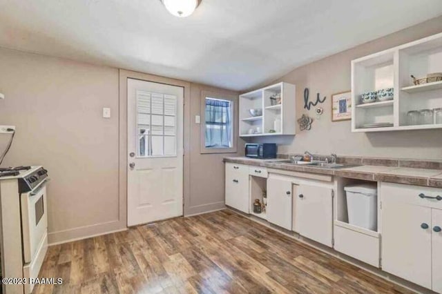 kitchen featuring a sink, open shelves, white range with gas cooktop, and white cabinetry