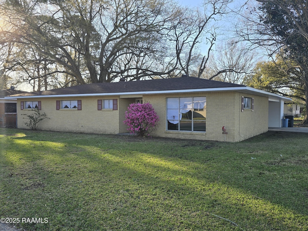 1519 Anderson St, New Iberia, LA 70560 - back of property featuring brick siding and a lawn