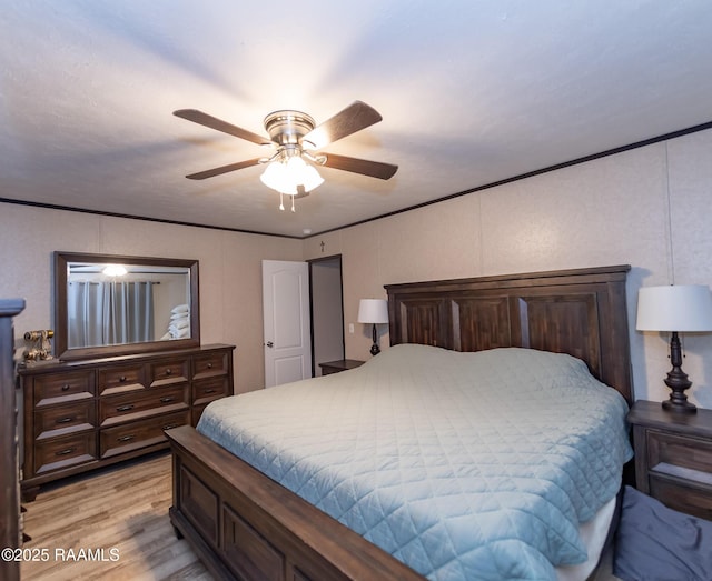 bedroom with light wood finished floors and ceiling fan