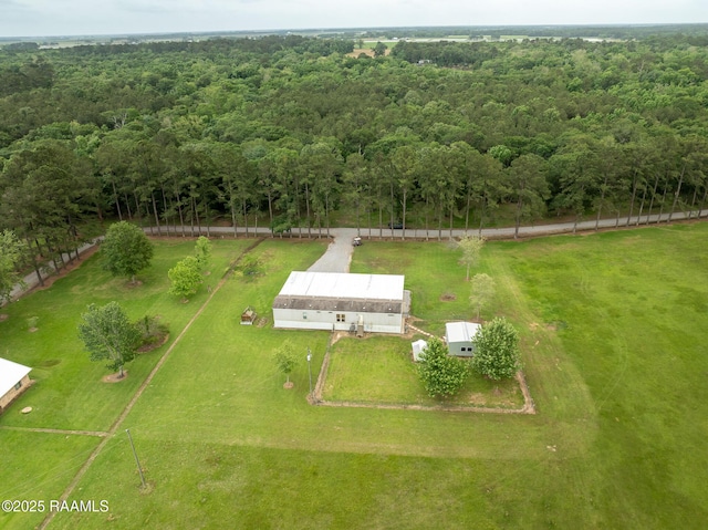 drone / aerial view featuring a view of trees