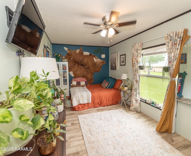bedroom featuring a ceiling fan and wood finished floors