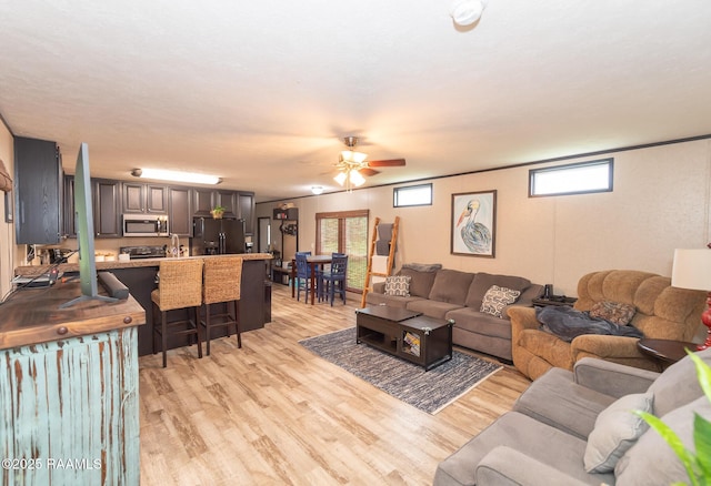 living area featuring ceiling fan and light wood-style floors