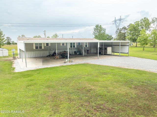back of house with a yard and a carport