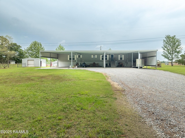view of front of property with a front lawn, an outbuilding, and driveway
