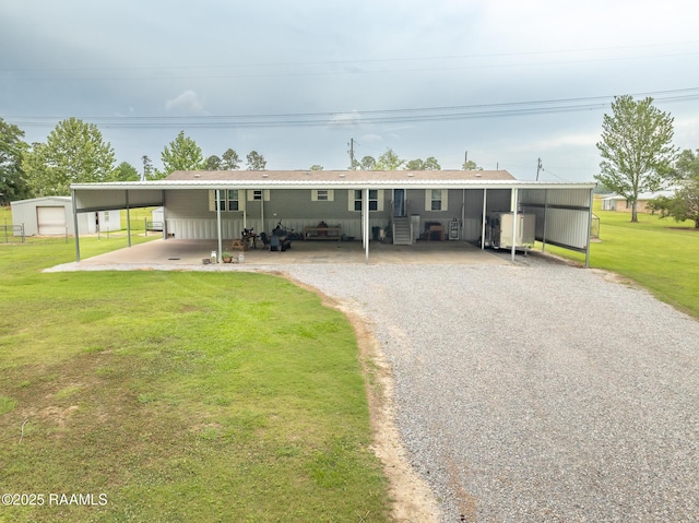 rear view of property featuring a lawn, entry steps, and driveway